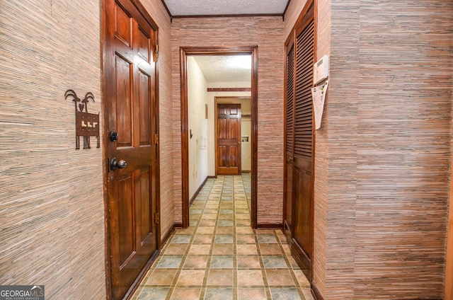 hallway with a textured ceiling