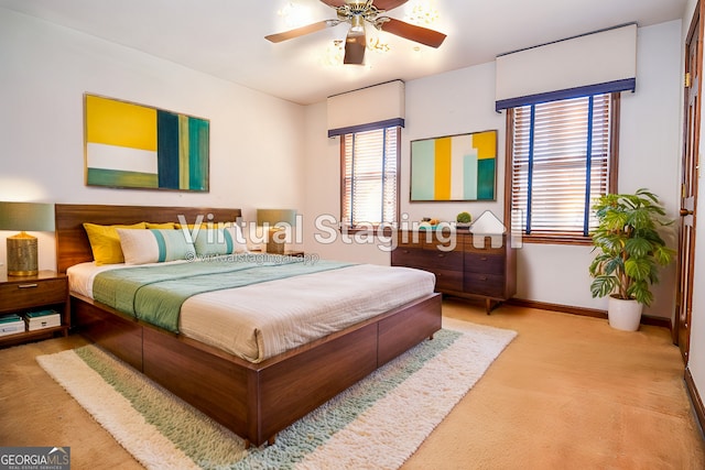 bedroom with ceiling fan, baseboards, and carpet floors