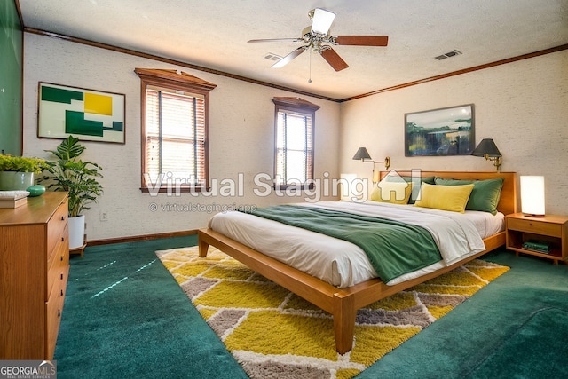 bedroom featuring ornamental molding, carpet, visible vents, and a textured ceiling