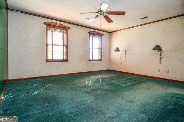 carpeted empty room with ornamental molding, a ceiling fan, visible vents, and a textured ceiling