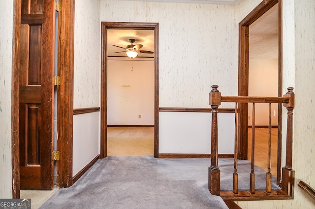 hallway with baseboards and carpet floors