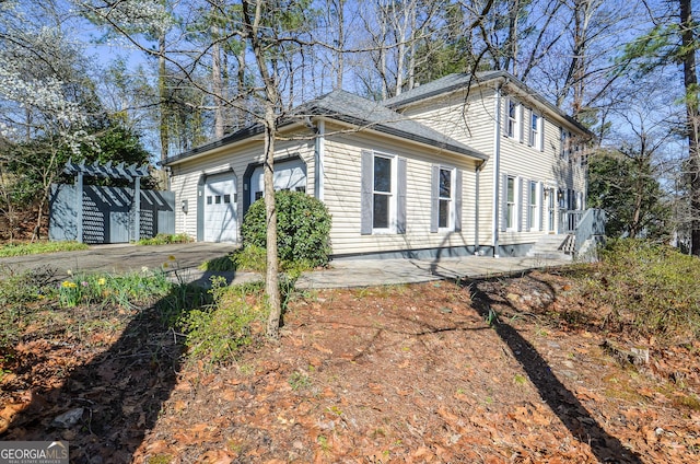 exterior space featuring driveway and an attached garage