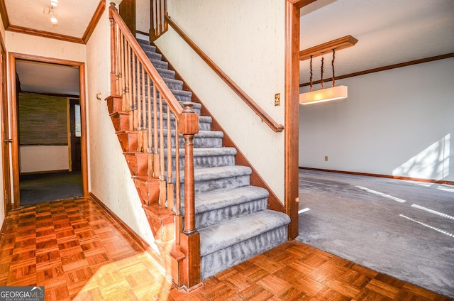 stairway featuring baseboards and ornamental molding