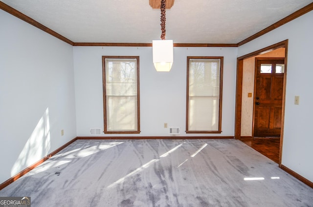 unfurnished dining area with visible vents, baseboards, and crown molding