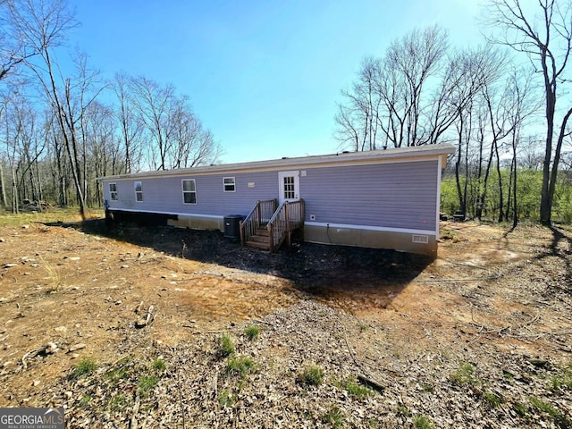 rear view of property featuring crawl space