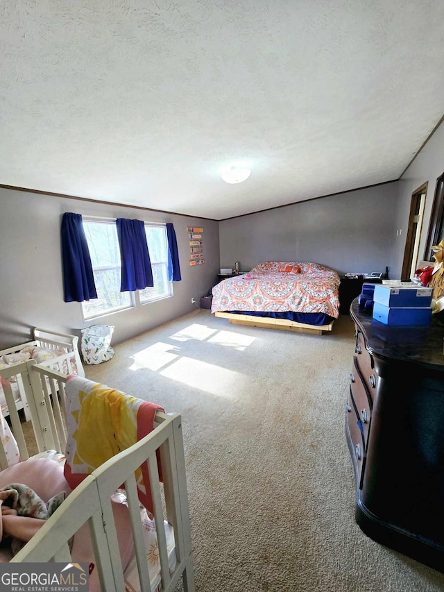 bedroom featuring carpet flooring and a textured ceiling