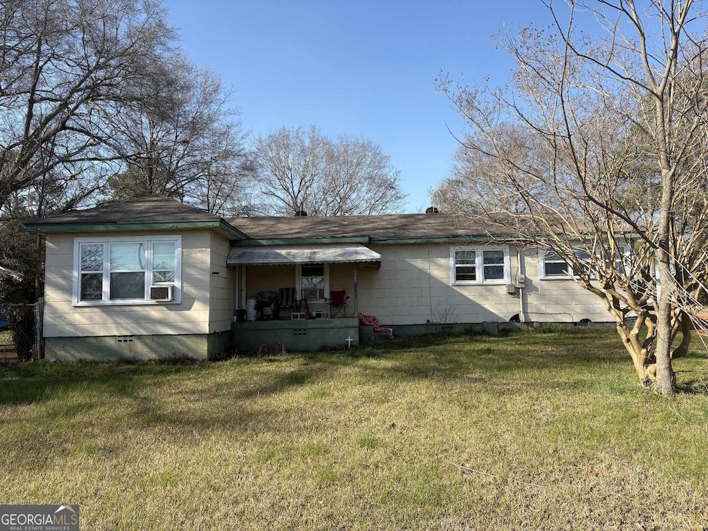 back of house with cooling unit, a lawn, and crawl space