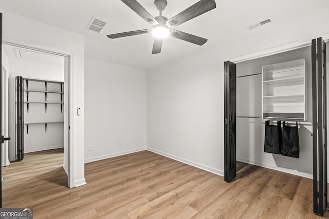 unfurnished bedroom featuring ceiling fan, baseboards, light wood-style floors, and visible vents