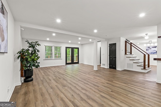 unfurnished living room with recessed lighting, stairway, visible vents, and wood finished floors