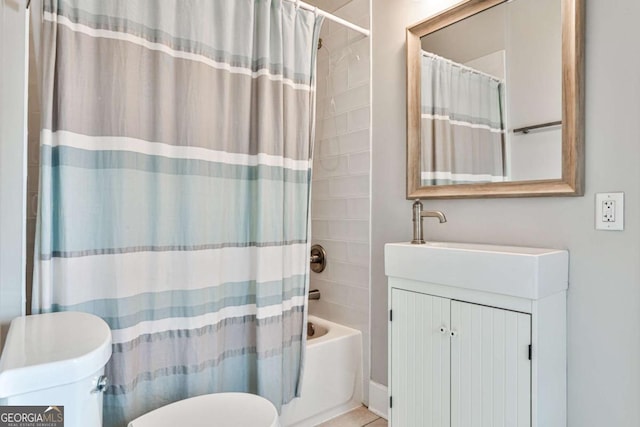 full bath with tile patterned floors, toilet, vanity, and shower / bath combo