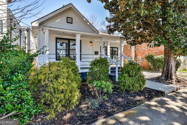 view of front of home with a porch and brick siding