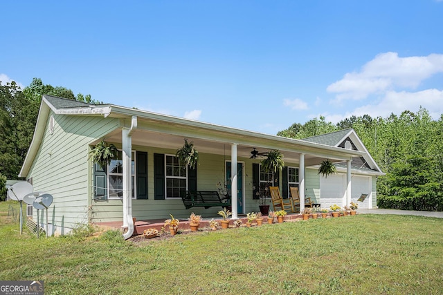 410 Bowen Rd NE, White, GA 30184 - view of front of home with a garage, a porch, a front yard, concrete driveway, and a ceiling fan