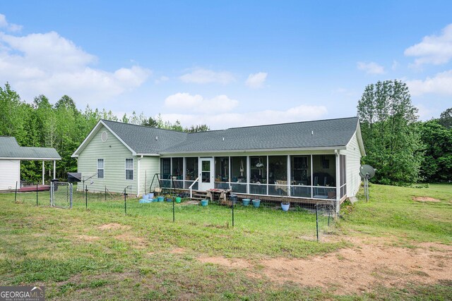 410 Bowen Rd NE, White, GA 30184 - back of house with a sunroom, a shingled roof, a lawn, and fence