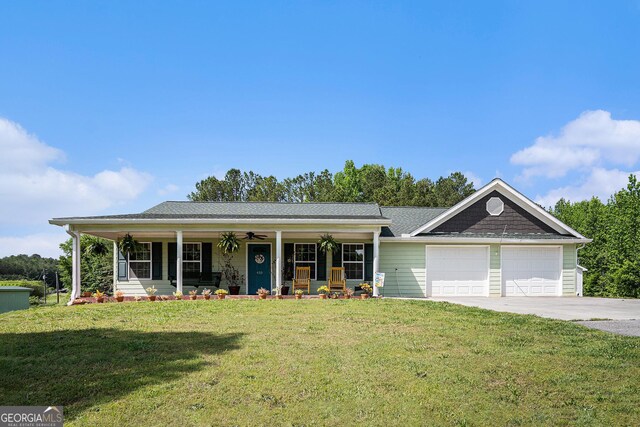 410 Bowen Rd NE, White, GA 30184 - view of front of house featuring covered porch, driveway, a ceiling fan, a front lawn, and an attached garage