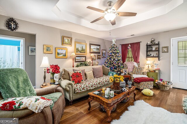 410 Bowen Rd NE, White, GA 30184 - living room with visible vents, a ceiling fan, a raised ceiling, and wood finished floors