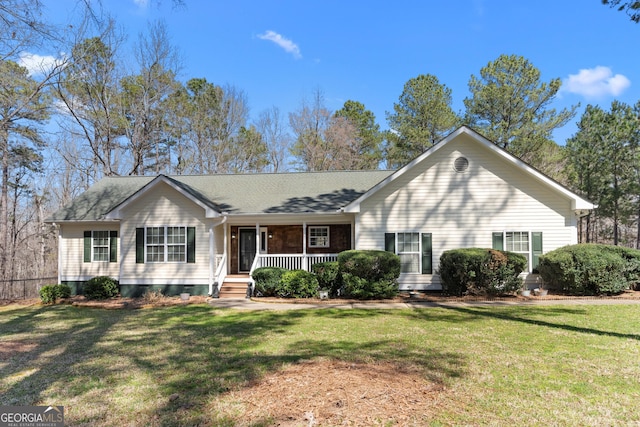 ranch-style home with a front yard and covered porch