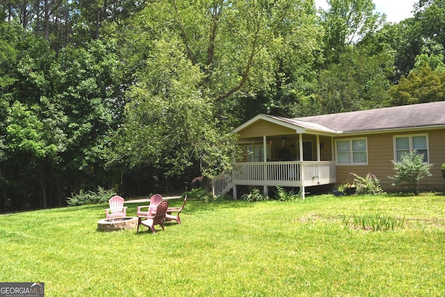 1537 David Lee St, Acworth, GA 30102 - back of property featuring a fire pit, a sunroom, a yard, and a shingled roof