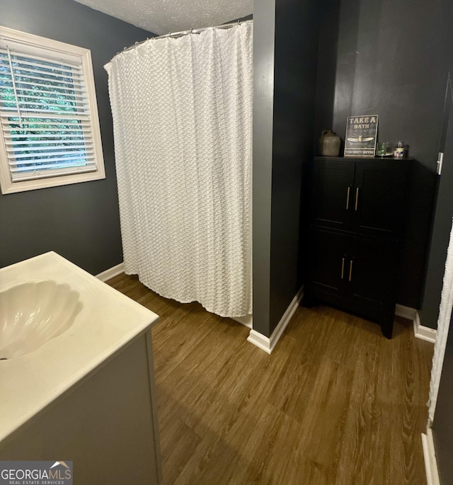 1537 David Lee St, Acworth, GA 30102 - full bath featuring wood finished floors, baseboards, and vanity