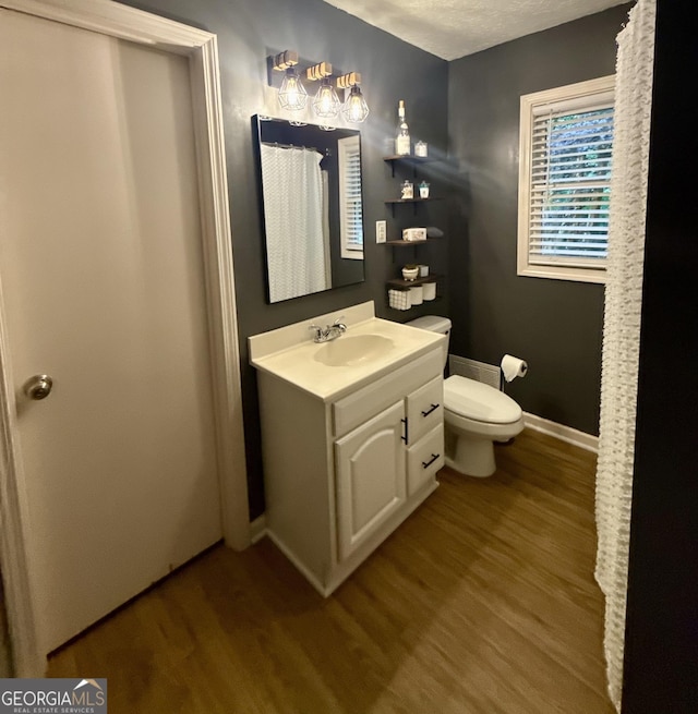 1537 David Lee St, Acworth, GA 30102 - bathroom featuring wood finished floors, toilet, baseboards, and vanity