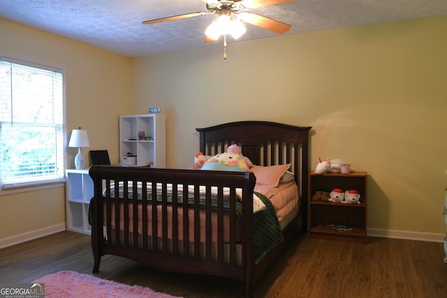 1537 David Lee St, Acworth, GA 30102 - bedroom with multiple windows, wood finished floors, baseboards, a textured ceiling, and ceiling fan