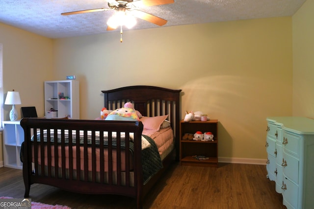 1537 David Lee St, Acworth, GA 30102 - bedroom with wood finished floors, a textured ceiling, baseboards, and a ceiling fan