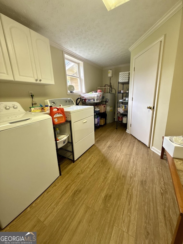1537 David Lee St, Acworth, GA 30102 - washroom with water heater, washing machine and clothes dryer, light wood finished floors, cabinet space, and a textured ceiling