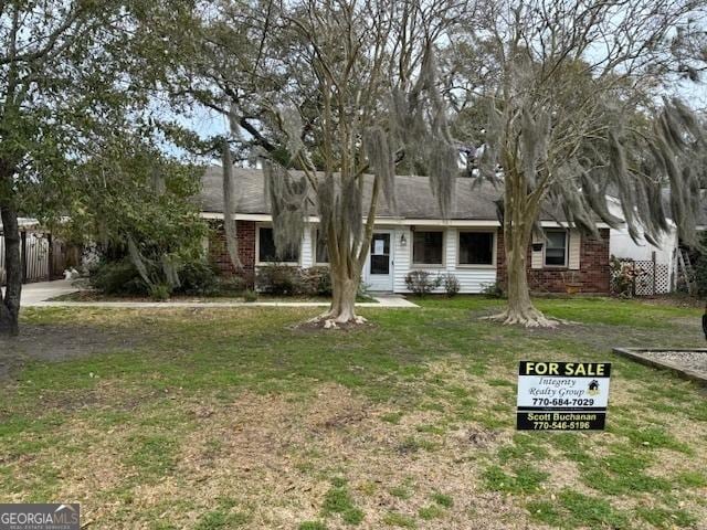 single story home with a front yard and brick siding