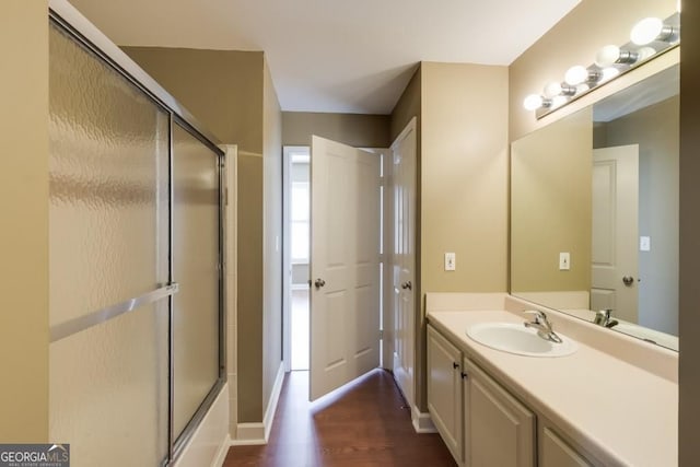 1101 Juniper St Unit 61, Atlanta, GA 30309 - bathroom with wood finished floors, a shower with shower door, vanity, and baseboards