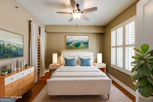 1101 Juniper St Unit 61, Atlanta, GA 30309 - bedroom featuring dark wood-style flooring, a ceiling fan, and baseboards