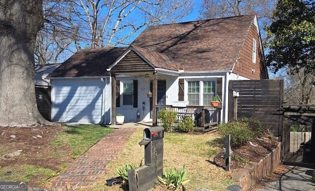 view of front of property with brick siding, covered porch, an attached garage, and a shingled roof