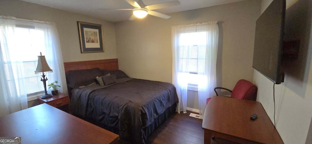 bedroom featuring wood finished floors, visible vents, and ceiling fan