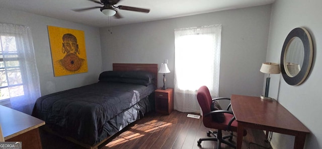 bedroom with visible vents, wood finished floors, and a ceiling fan