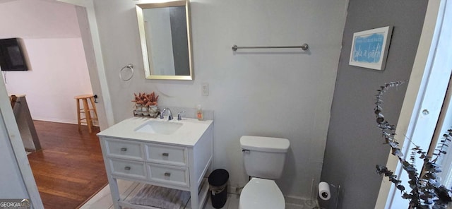 bathroom with vanity, toilet, and wood finished floors