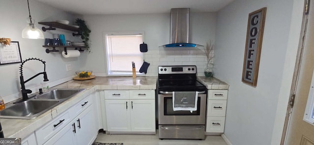 kitchen with electric range, a sink, open shelves, wall chimney exhaust hood, and light countertops