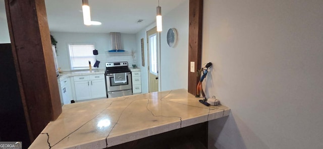 kitchen with stainless steel electric stove, pendant lighting, wall chimney exhaust hood, and decorative backsplash