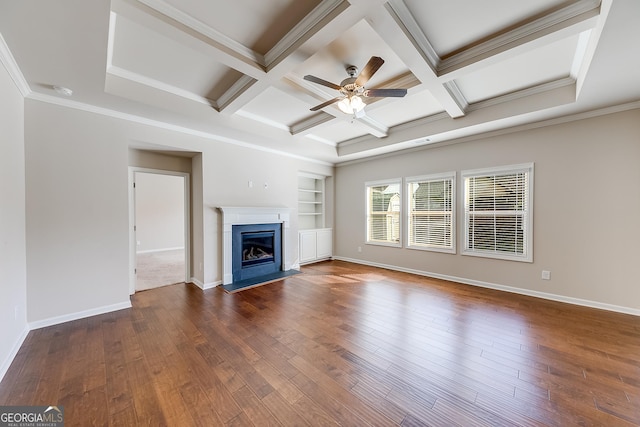 unfurnished living room featuring baseboards, coffered ceiling, and hardwood / wood-style flooring