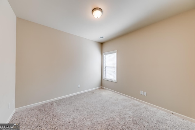 empty room with visible vents, carpet, and baseboards