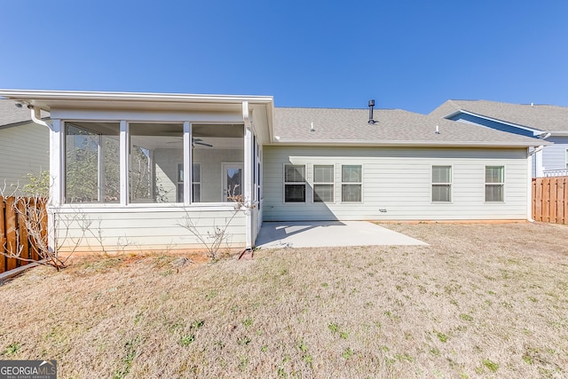 back of house with a patio, fence, a sunroom, a shingled roof, and a lawn