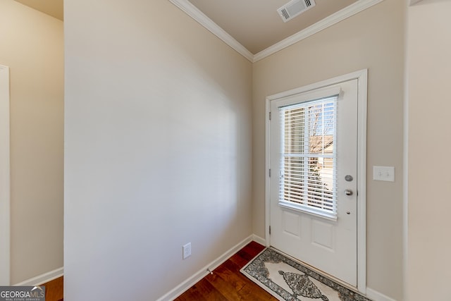 doorway featuring baseboards, dark wood-style floors, visible vents, and ornamental molding