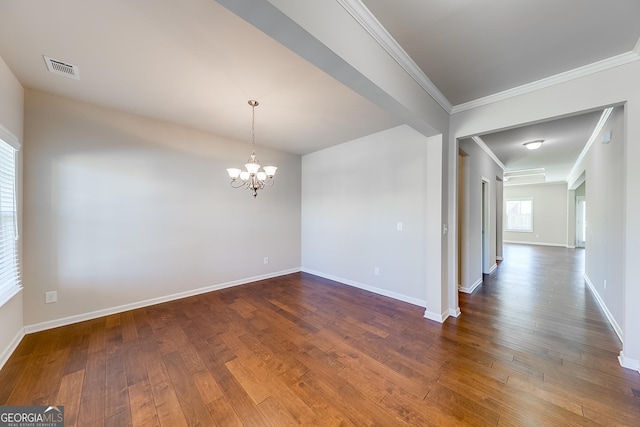 unfurnished room featuring visible vents, wood-type flooring, baseboards, and an inviting chandelier