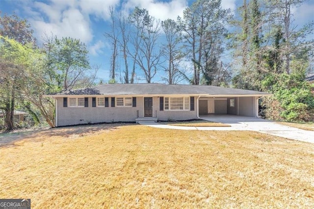 ranch-style home with crawl space, a carport, concrete driveway, and a front lawn