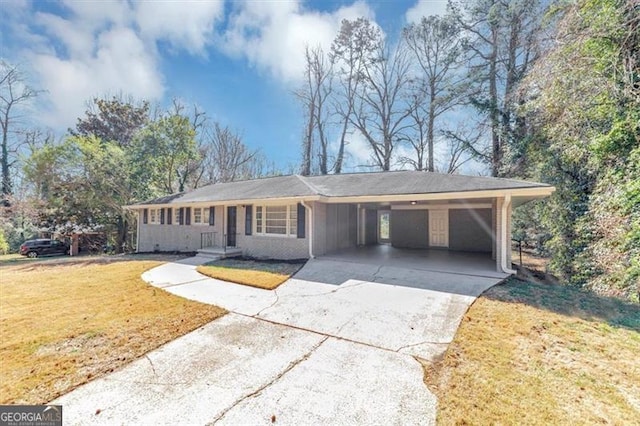 ranch-style house featuring a carport, a front lawn, brick siding, and driveway