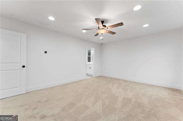 spare room featuring visible vents, recessed lighting, baseboards, light colored carpet, and ceiling fan