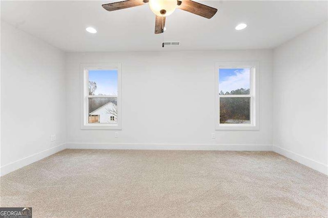 unfurnished room featuring recessed lighting, visible vents, light colored carpet, and baseboards