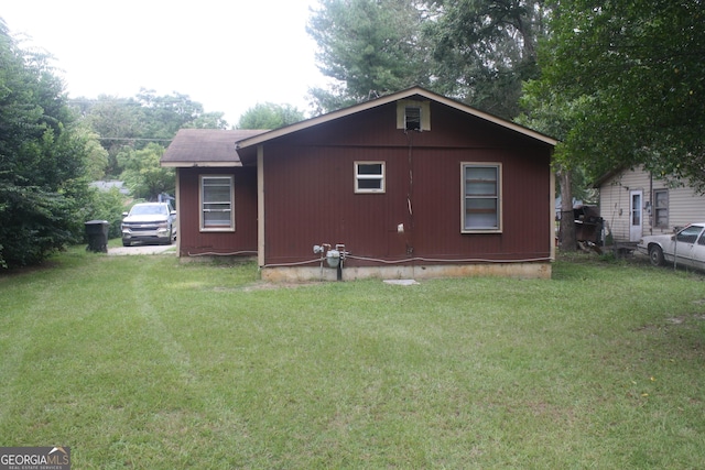 view of side of property with a yard