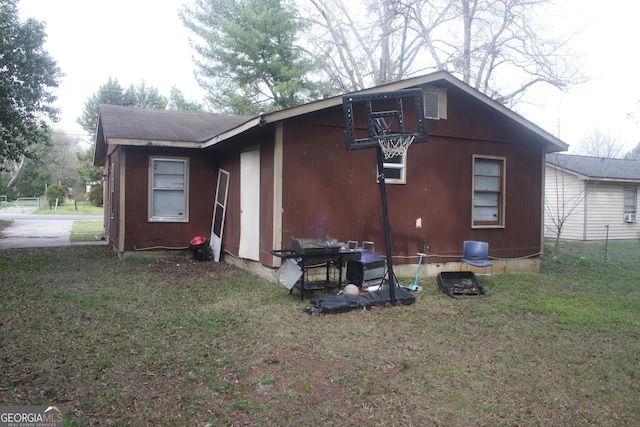 view of property exterior with a lawn and a shingled roof