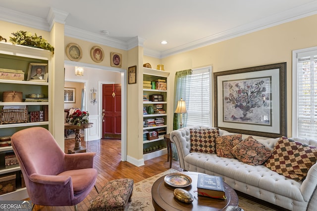 living room featuring crown molding and wood finished floors