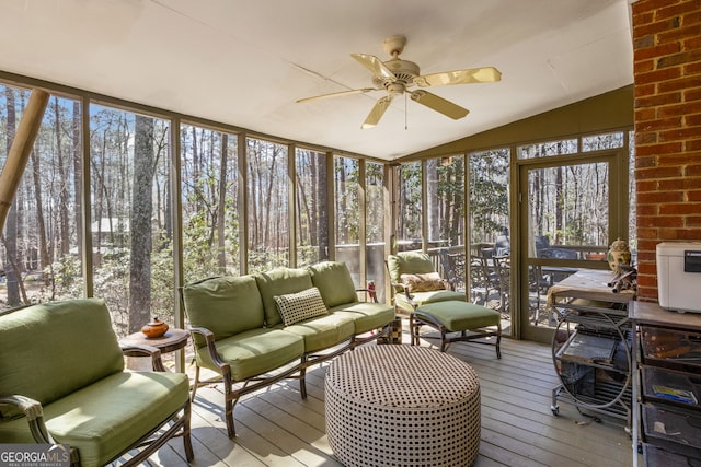 sunroom / solarium with plenty of natural light, a ceiling fan, and vaulted ceiling