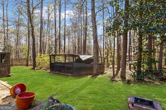 view of yard with a fire pit and fence