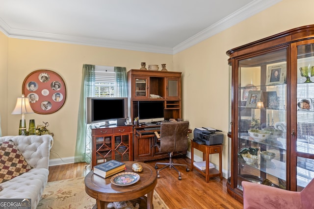 office space featuring crown molding, baseboards, and wood finished floors